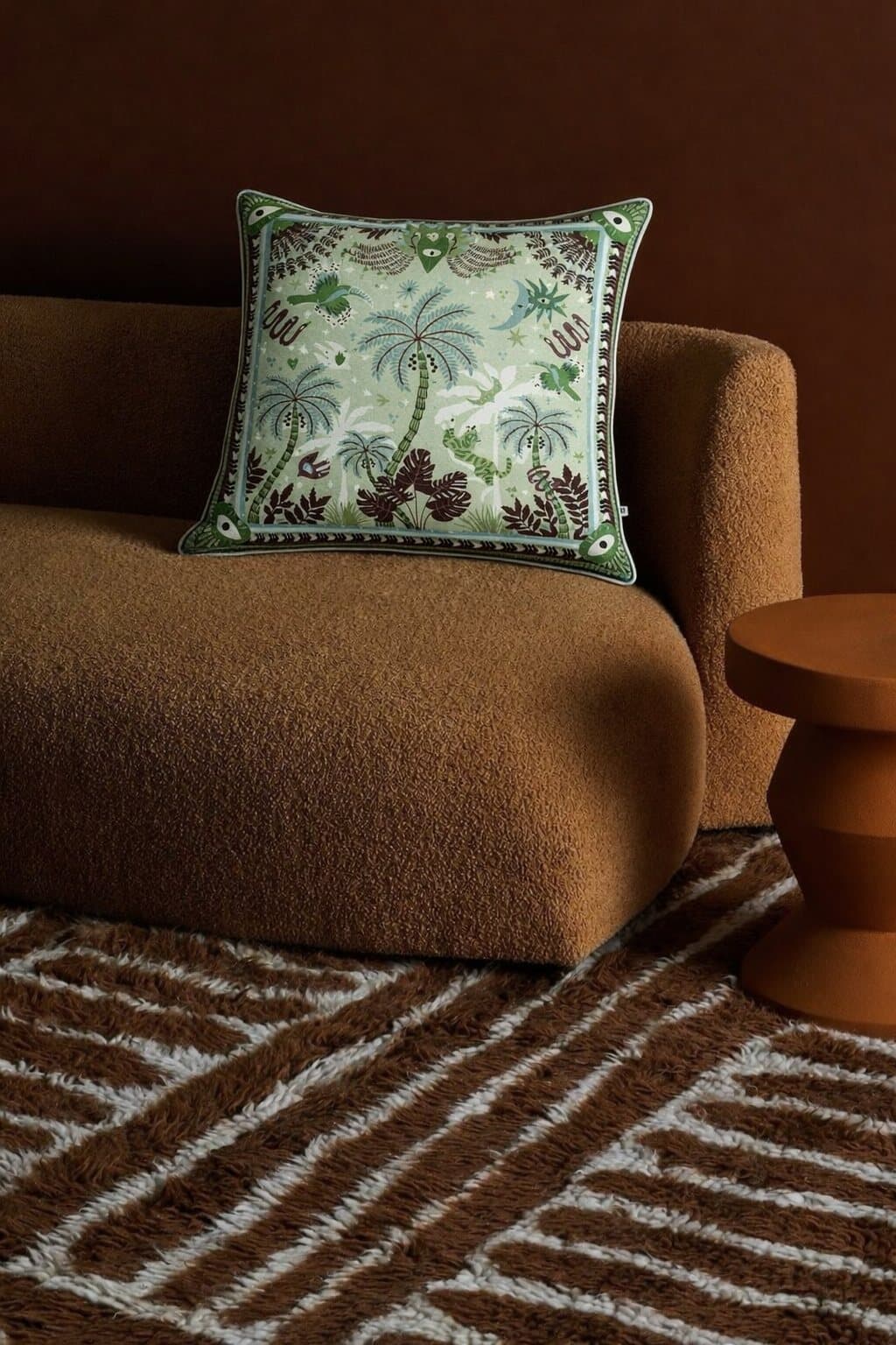 A cushion on a boucle sofa